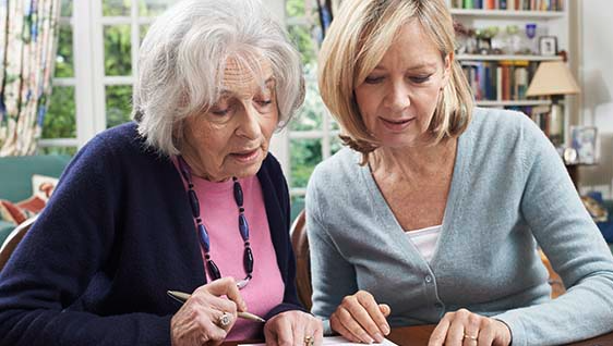 Elderly woman smiling in a supportive conversation