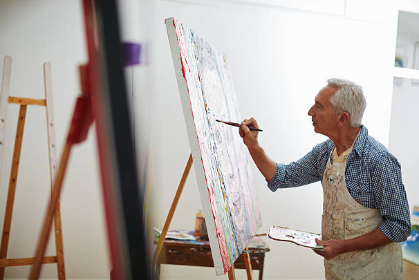 Elderly person doing a painting activity