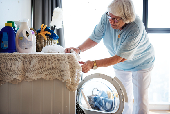 Older person folding laundry calmly
